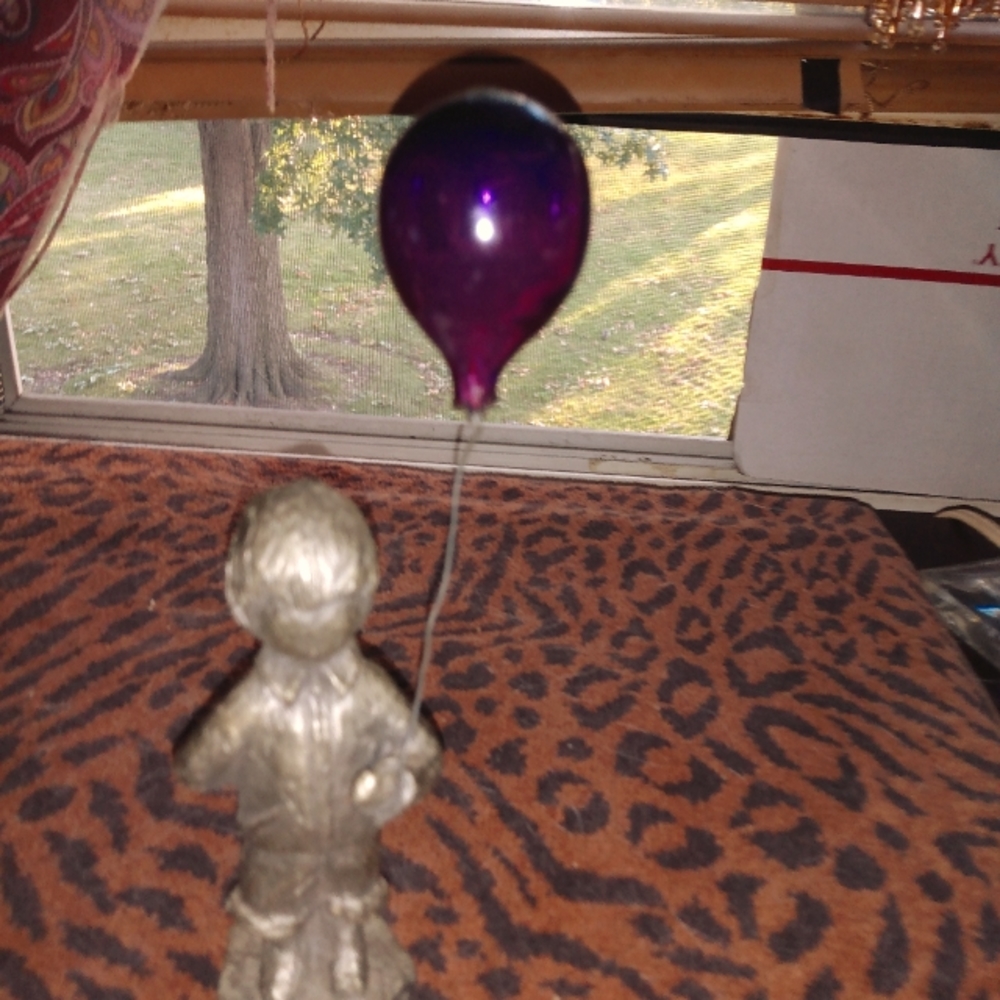 Pewter boy statue with glass balloon